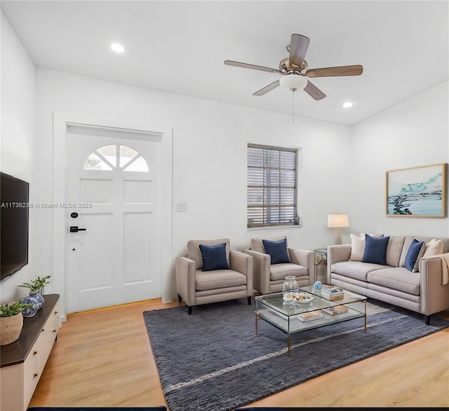 living room with light wood-type flooring, a healthy amount of sunlight, and recessed lighting