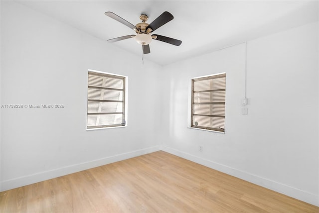 unfurnished room with ceiling fan, light wood-style flooring, and baseboards