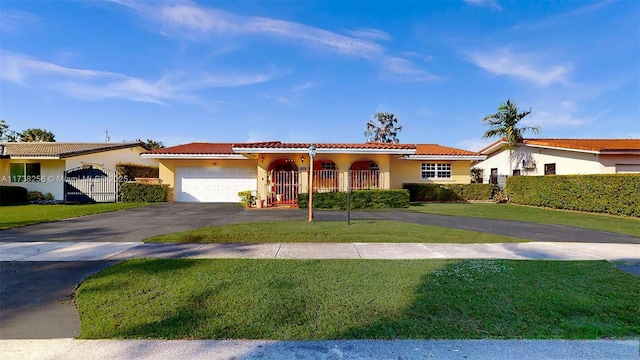 mediterranean / spanish-style home with a garage and a front yard