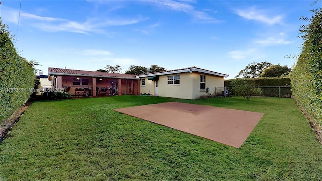 back of property featuring a yard and a patio area