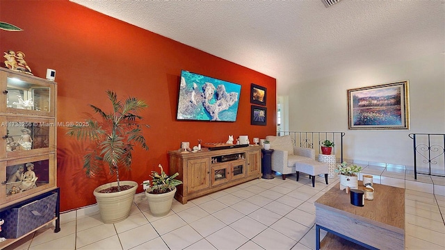living room featuring a textured ceiling and light tile patterned flooring