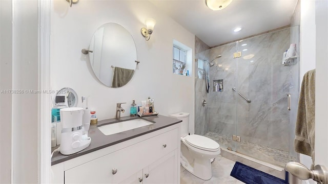 bathroom featuring walk in shower, vanity, and toilet