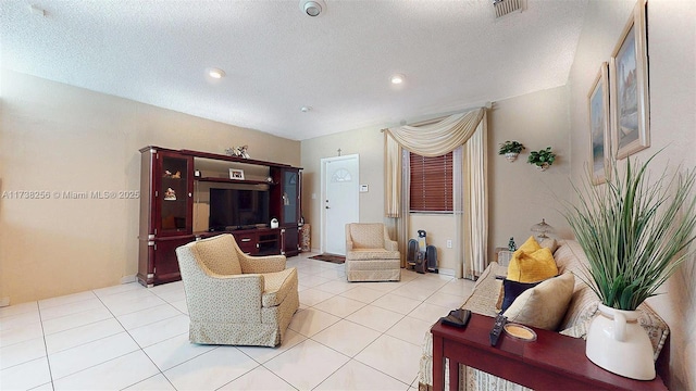 living room with light tile patterned floors and a textured ceiling