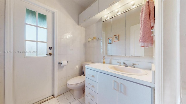 bathroom featuring tile walls, backsplash, vanity, tile patterned floors, and toilet