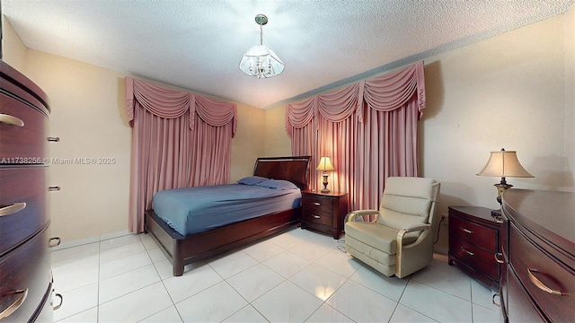 bedroom featuring light tile patterned floors and a textured ceiling