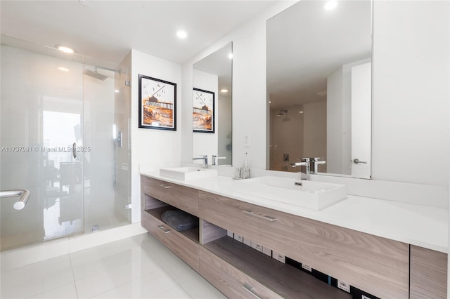 bathroom featuring vanity, a shower with door, and tile patterned floors