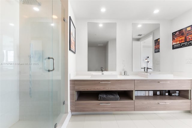 bathroom with vanity and a shower with door