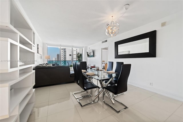 dining room featuring a chandelier, visible vents, baseboards, and light tile patterned floors