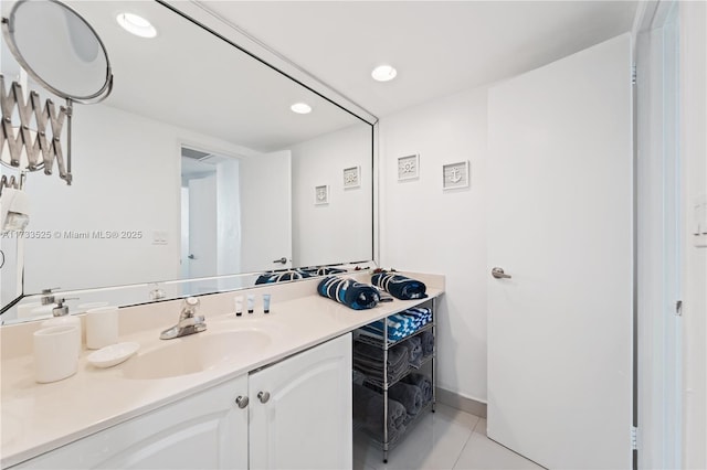 bathroom featuring recessed lighting, vanity, baseboards, and tile patterned floors