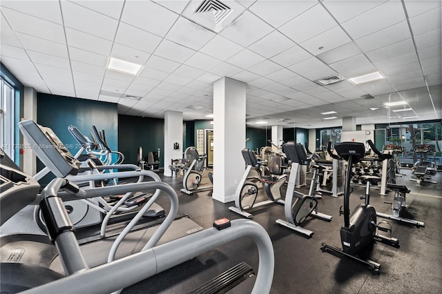 gym with baseboards, visible vents, and a drop ceiling