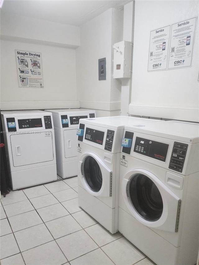 community laundry room with stacked washer and dryer, independent washer and dryer, and light tile patterned flooring