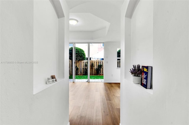 hall with wood-type flooring