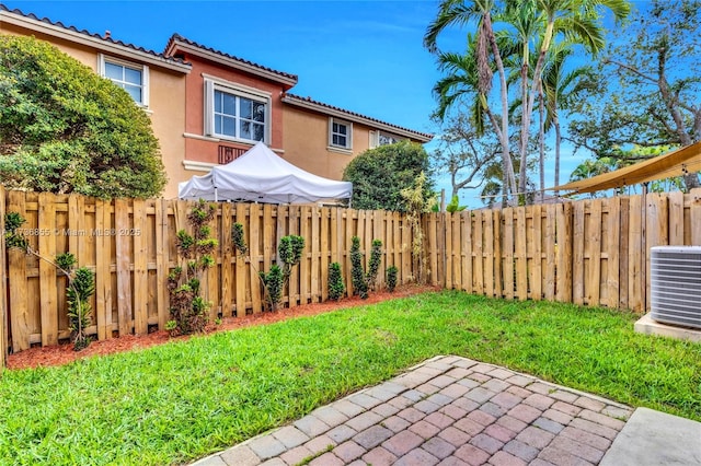 view of yard featuring cooling unit and a patio