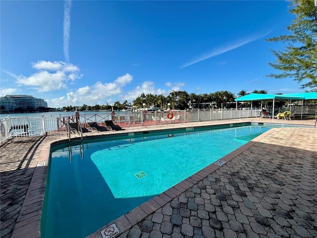 view of swimming pool with a water view