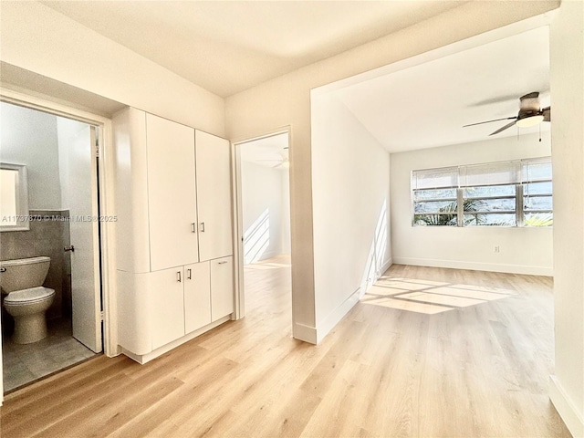 corridor with light hardwood / wood-style flooring