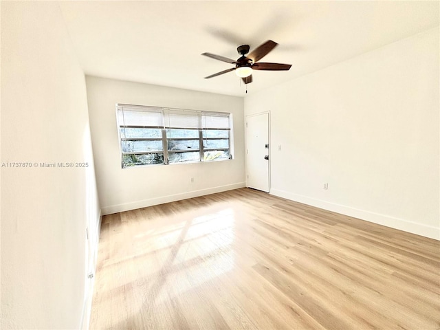 spare room featuring light hardwood / wood-style floors and ceiling fan