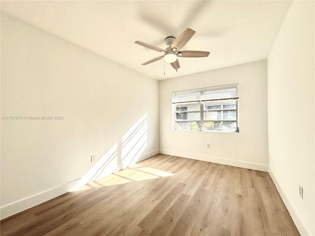 empty room featuring ceiling fan and light hardwood / wood-style floors