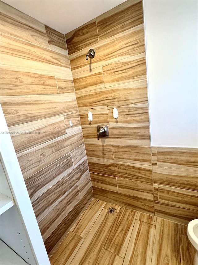 bathroom with tiled shower