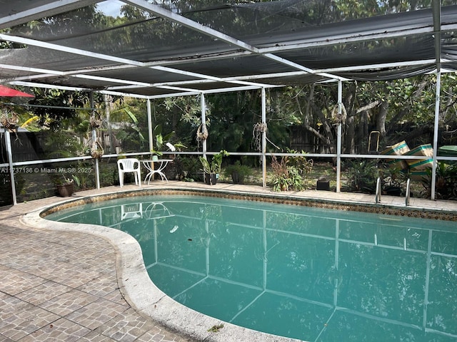 view of pool featuring a lanai and a patio area