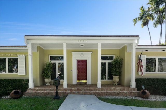 entrance to property featuring covered porch