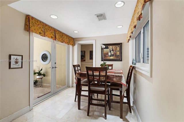 dining room featuring french doors and light tile patterned flooring