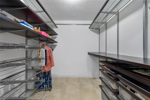 spacious closet with light tile patterned flooring