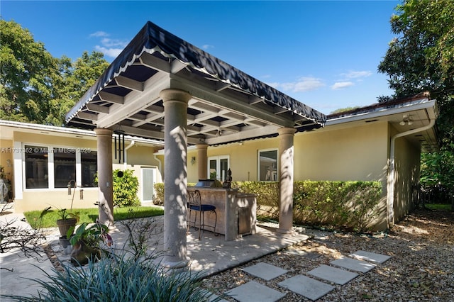 rear view of property featuring a bar and a patio area