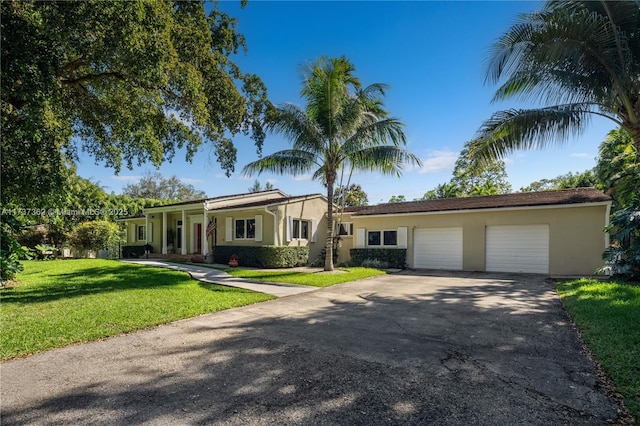 single story home featuring a garage and a front yard