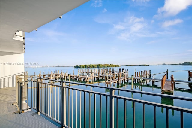 balcony featuring a water view and a boat dock