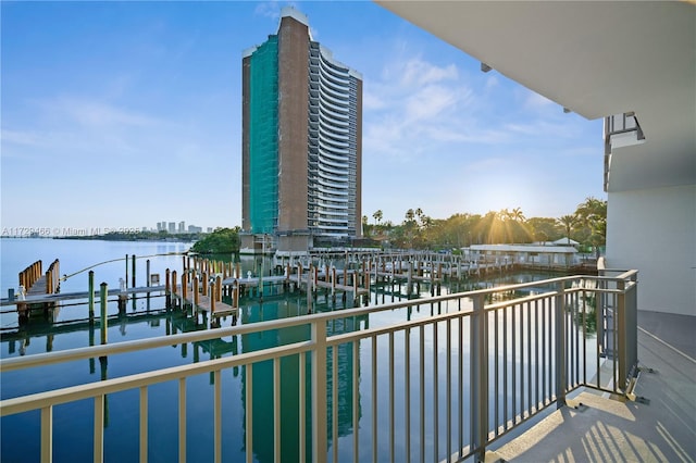 balcony with a boat dock and a water view