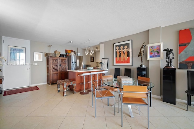 dining room featuring light tile patterned flooring and a textured ceiling