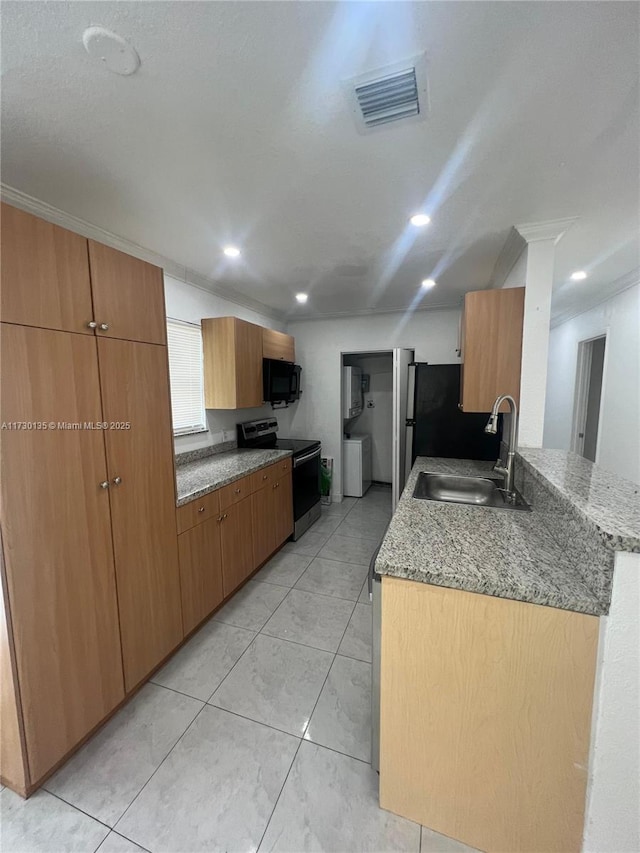 kitchen with sink, crown molding, stainless steel appliances, light stone counters, and kitchen peninsula