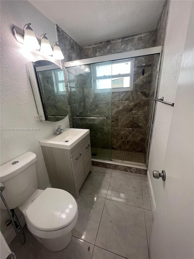 bathroom with walk in shower, vanity, a textured ceiling, and toilet