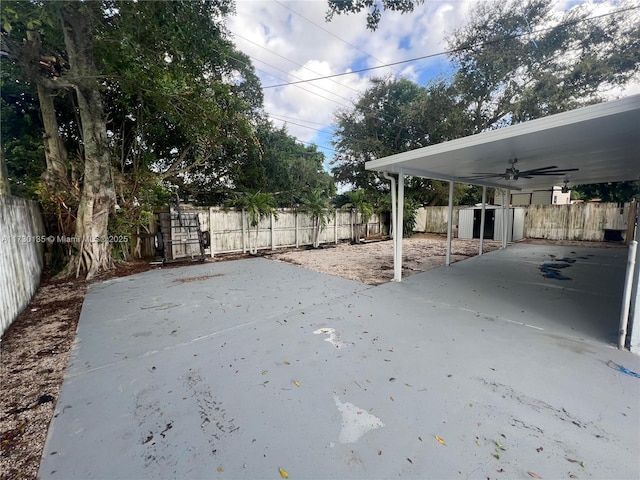 view of yard with ceiling fan and a shed