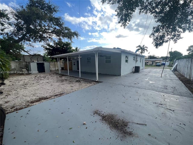 back of house featuring cooling unit