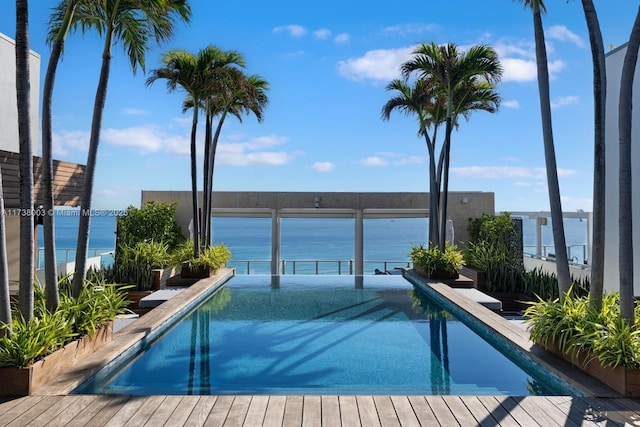 view of swimming pool featuring a water view