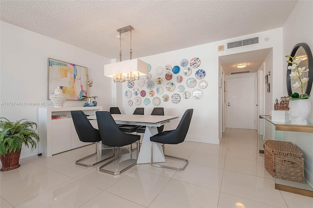 tiled dining space featuring a textured ceiling and a notable chandelier