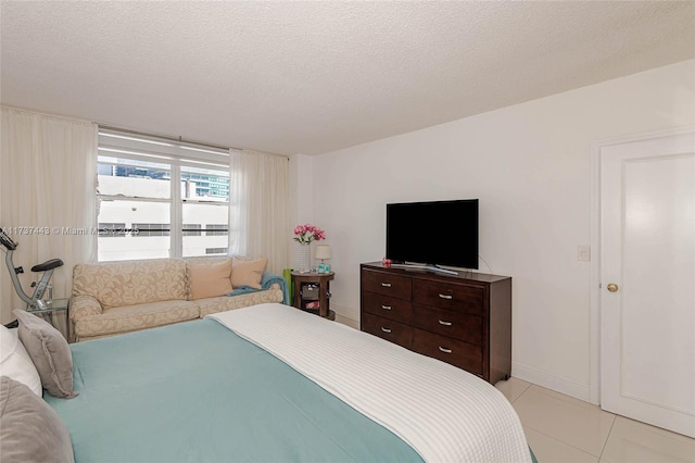 bedroom featuring a textured ceiling and light tile patterned floors