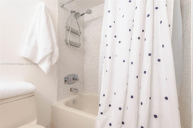 bathroom with toilet and shower / bath combo with shower curtain