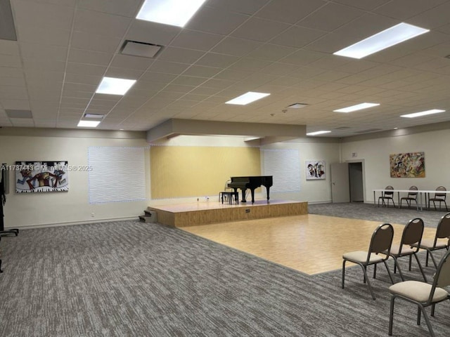 interior space with carpet flooring and a drop ceiling