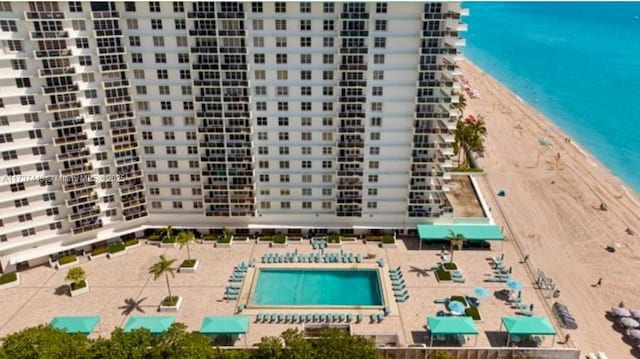 aerial view featuring a water view and a beach view