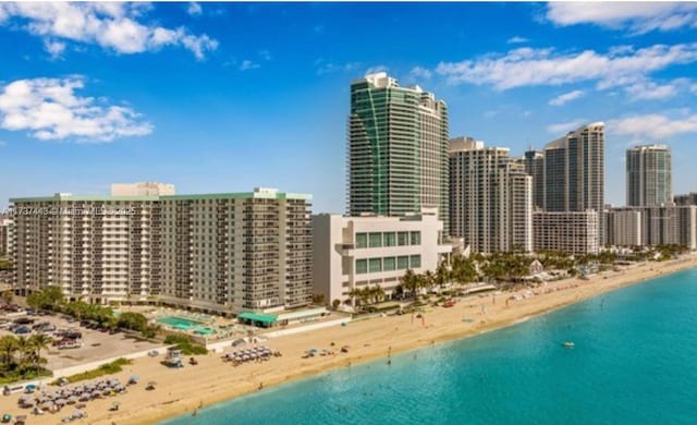 drone / aerial view featuring a view of the beach and a water view