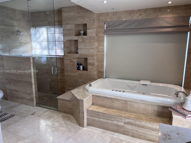 bathroom featuring tile patterned floors, plus walk in shower, and tile walls