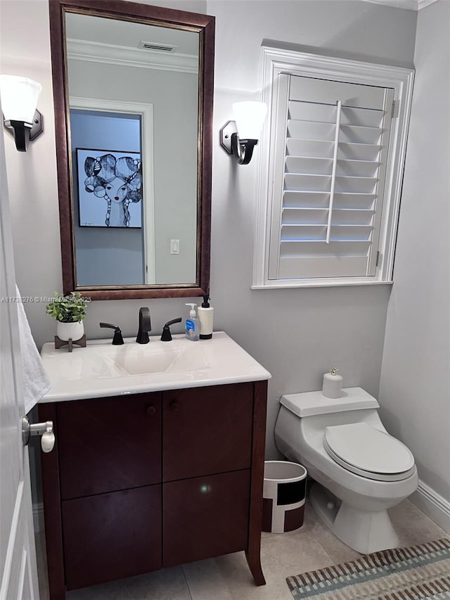 bathroom with ornamental molding, vanity, toilet, and tile patterned flooring