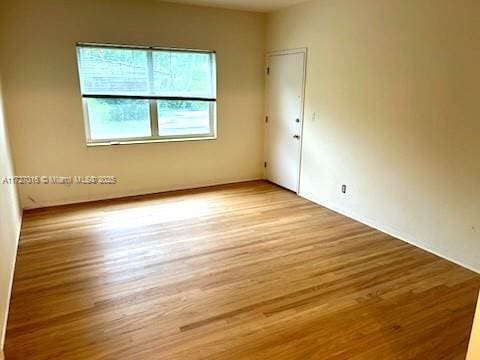 spare room with light wood-type flooring