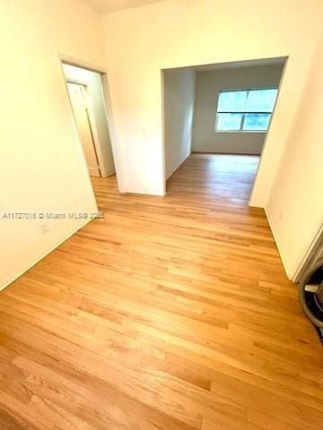 corridor with light hardwood / wood-style flooring