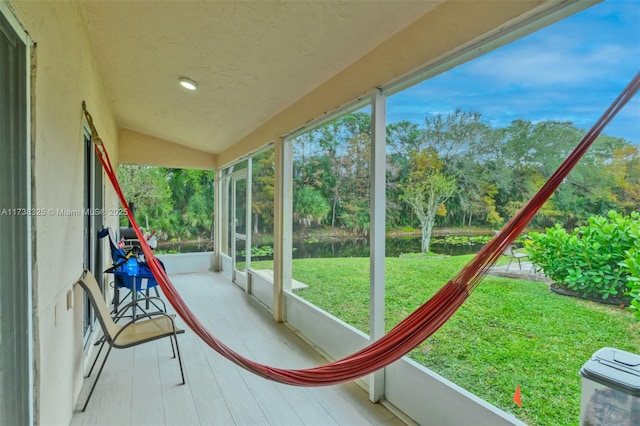 unfurnished sunroom featuring a wealth of natural light and vaulted ceiling