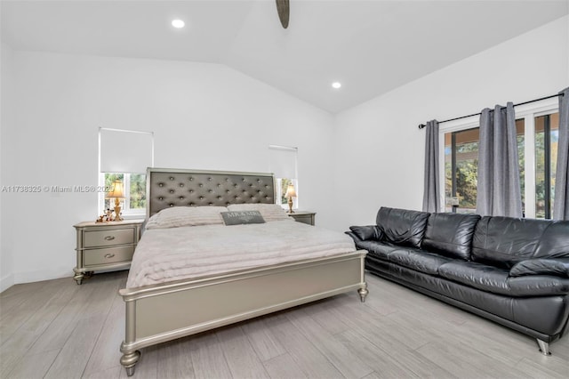 bedroom featuring ceiling fan, lofted ceiling, and light hardwood / wood-style flooring