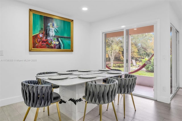 dining area with hardwood / wood-style floors