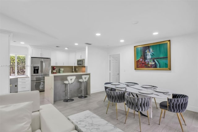 dining space featuring light hardwood / wood-style flooring